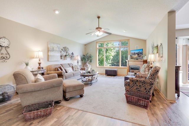 2301 170th Ln NW, Andover, MN 55304 - living area with ceiling fan, a fireplace, wood finished floors, and vaulted ceiling