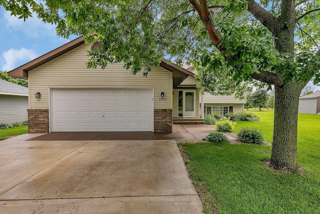 1294 Stone Ridge Rd, Sauk Rapids, MN 56379 - tri-level home with brick siding, a front yard, driveway, and a garage