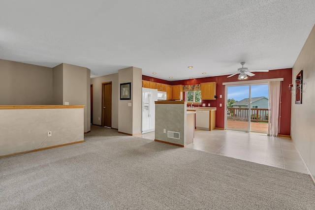 1294 Stone Ridge Rd, Sauk Rapids, MN 56379 - unfurnished living room with ceiling fan, a textured ceiling, and light colored carpet