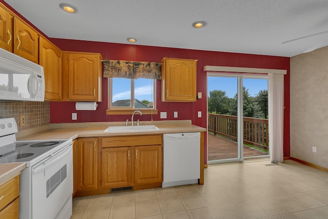 1294 Stone Ridge Rd, Sauk Rapids, MN 56379 - kitchen featuring white appliances, light countertops, brown cabinetry, decorative backsplash, and a textured ceiling