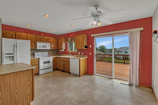 1294 Stone Ridge Rd, Sauk Rapids, MN 56379 - kitchen featuring white appliances, light countertops, tasteful backsplash, a ceiling fan, and a textured ceiling