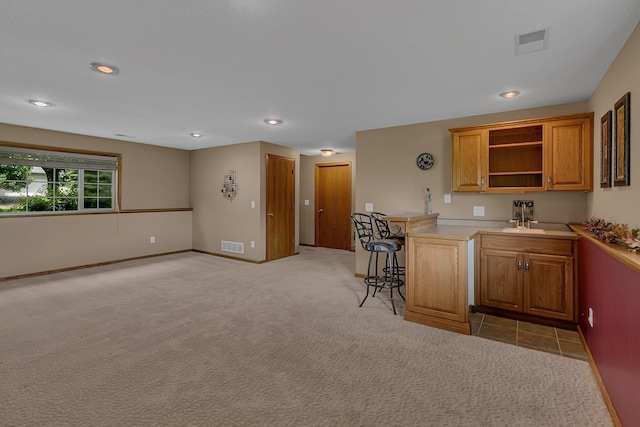 1294 Stone Ridge Rd, Sauk Rapids, MN 56379 - kitchen with light colored carpet, open shelves, light countertops, recessed lighting, and brown cabinets