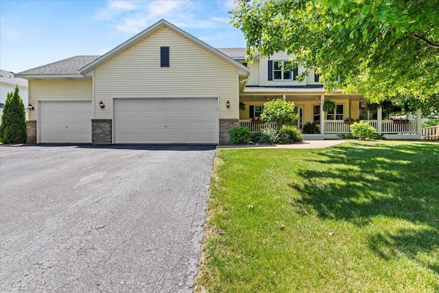 1111 Woods Creek Dr, Delano, MN 55328 - view of front of property with asphalt driveway, brick siding, a front yard, an attached garage, and a porch