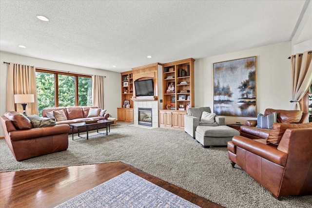 1111 Woods Creek Dr, Delano, MN 55328 - living area with a textured ceiling, a fireplace, recessed lighting, and wood finished floors