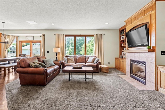 1111 Woods Creek Dr, Delano, MN 55328 - living room with plenty of natural light, a textured ceiling, a tiled fireplace, a chandelier, and recessed lighting