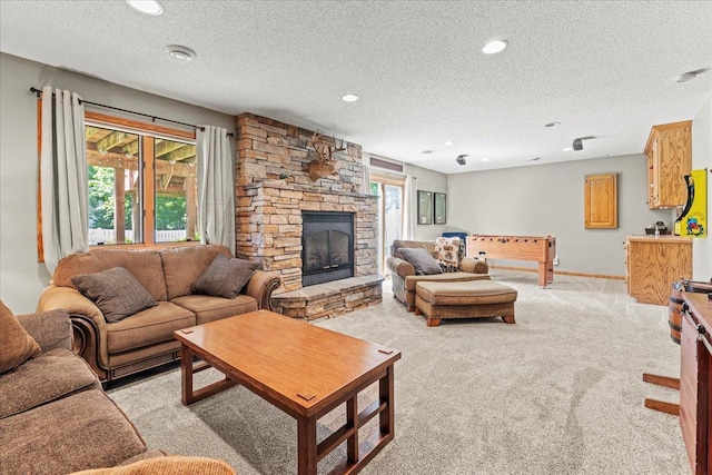 1111 Woods Creek Dr, Delano, MN 55328 - living area with a textured ceiling, light colored carpet, a fireplace, and recessed lighting