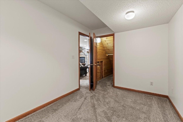 1111 Woods Creek Dr, Delano, MN 55328 - empty room featuring carpet flooring, a textured ceiling, and wood walls