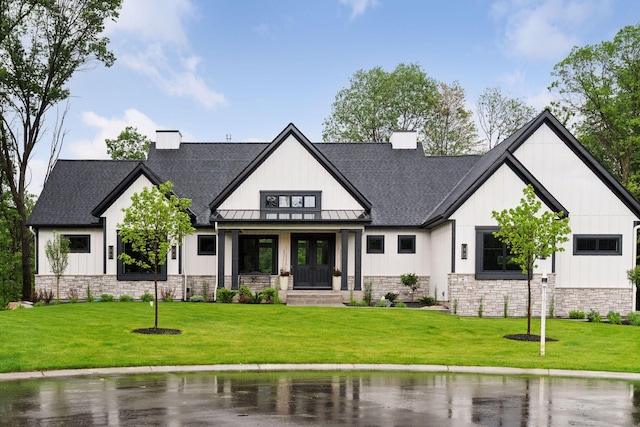 4864 148th Ave, Ham Lake, MN 55304 - modern inspired farmhouse with stone siding, a chimney, roof with shingles, a standing seam roof, and a front lawn
