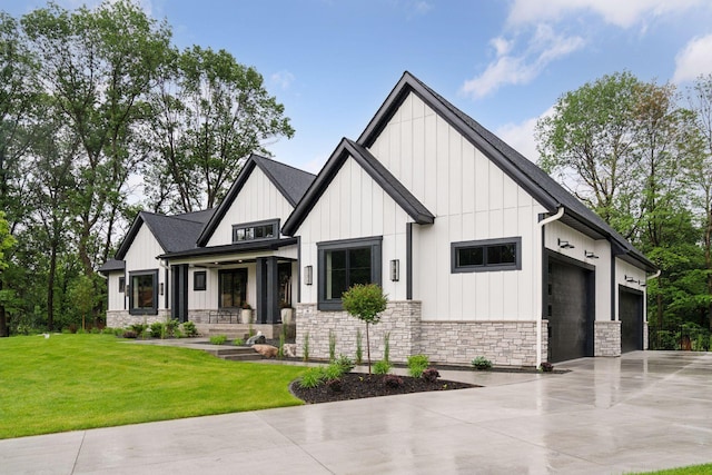 4864 148th Ave, Ham Lake, MN 55304 - modern inspired farmhouse featuring stone siding, a garage, board and batten siding, driveway, and a front lawn
