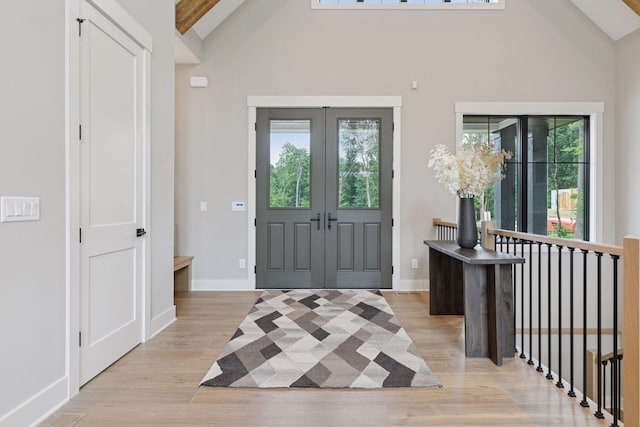 4864 148th Ave, Ham Lake, MN 55304 - foyer featuring healthy amount of natural light, french doors, light wood finished floors, and high vaulted ceiling