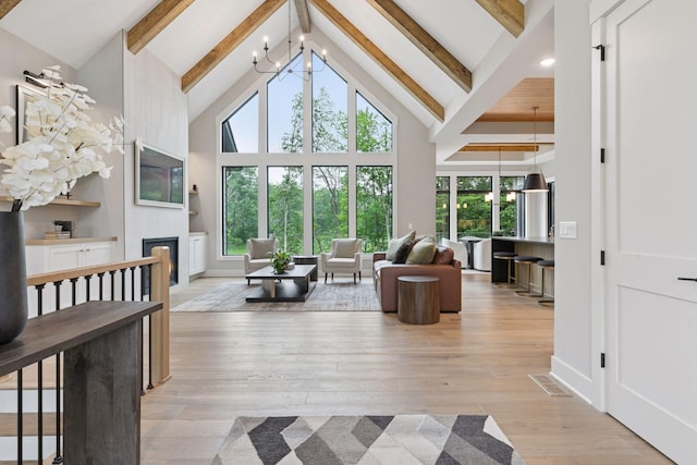4864 148th Ave, Ham Lake, MN 55304 - living area featuring a chandelier, beam ceiling, plenty of natural light, high vaulted ceiling, and hardwood / wood-style flooring