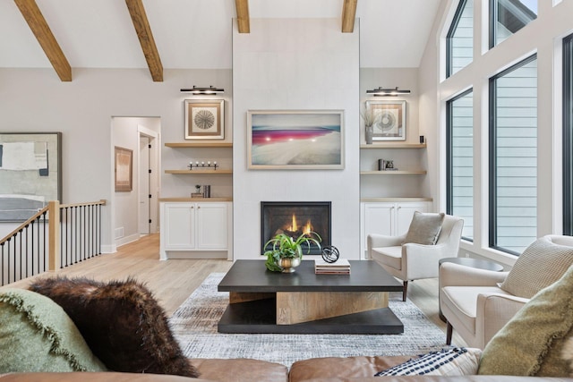 4864 148th Ave, Ham Lake, MN 55304 - living room featuring light wood-type flooring, beam ceiling, a tiled fireplace, and built in features