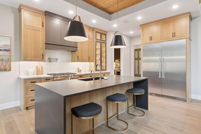 4864 148th Ave, Ham Lake, MN 55304 - kitchen featuring stainless steel appliances, light wood-style flooring, light brown cabinetry, a breakfast bar, and wood ceiling