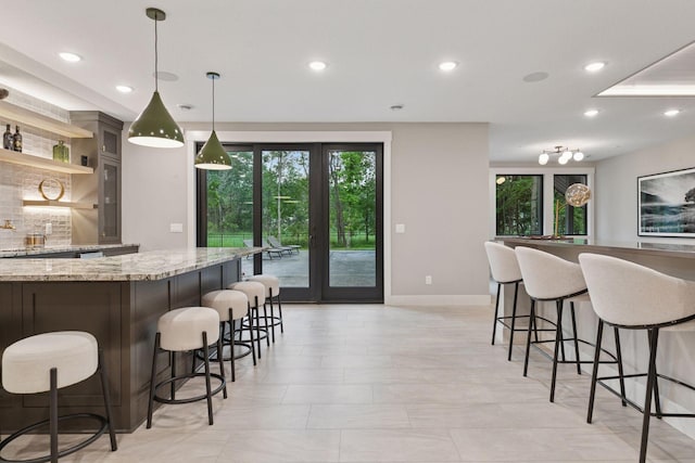 4864 148th Ave, Ham Lake, MN 55304 - kitchen with a kitchen bar, recessed lighting, light stone counters, decorative light fixtures, and open shelves