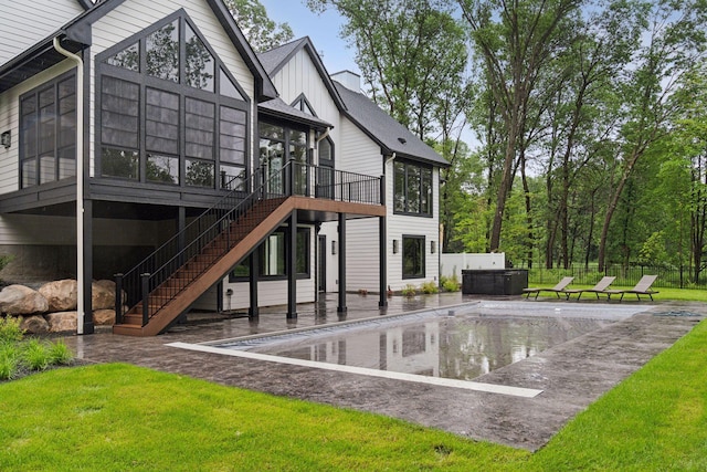 4864 148th Ave, Ham Lake, MN 55304 - back of house featuring a sunroom, a hot tub, a covered pool, a patio area, and stairway