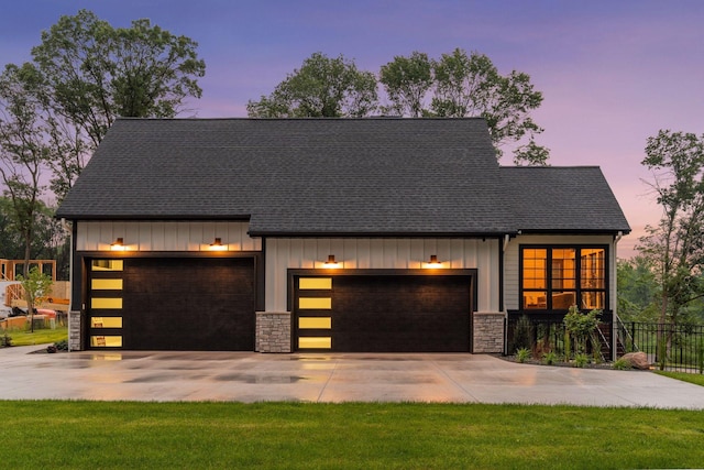 4864 148th Ave, Ham Lake, MN 55304 - view of front of property with board and batten siding, concrete driveway, and stone siding