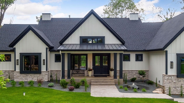 4864 148th Ave, Ham Lake, MN 55304 - modern inspired farmhouse with stone siding, a chimney, a standing seam roof, and roof with shingles