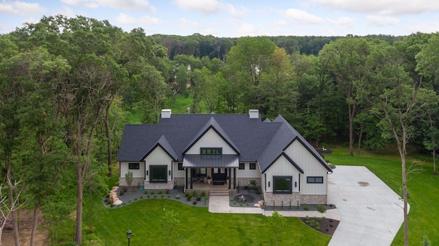 4864 148th Ave, Ham Lake, MN 55304 - view of front facade featuring a forest view, board and batten siding, and a chimney
