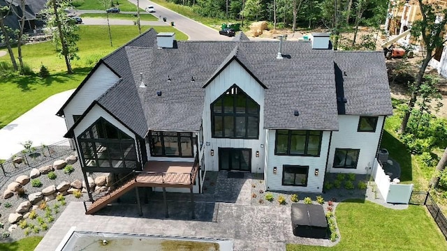 4864 148th Ave, Ham Lake, MN 55304 - back of house with roof with shingles, a patio area, and a sunroom