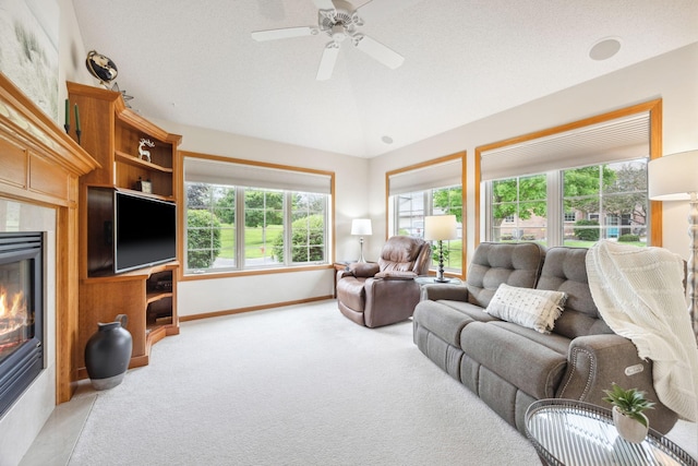 4438 Napier Pkwy NE, Saint Michael, MN 55376 - carpeted living area featuring lofted ceiling, a glass covered fireplace, and a ceiling fan