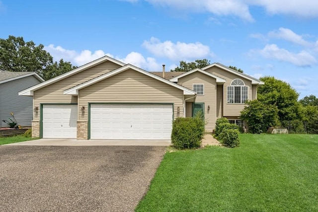 15271 Sodium St NW, Ramsey, MN 55303 - tri-level home featuring asphalt driveway, an attached garage, and a front yard