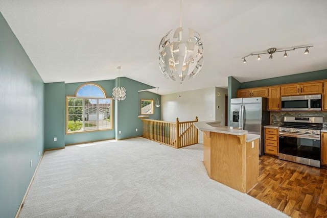 15271 Sodium St NW, Ramsey, MN 55303 - kitchen with stainless steel appliances, a chandelier, light countertops, lofted ceiling, and open floor plan