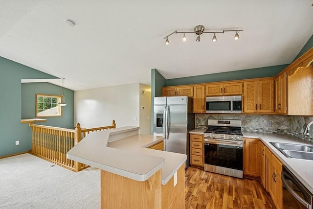 15271 Sodium St NW, Ramsey, MN 55303 - kitchen with stainless steel appliances, light countertops, decorative backsplash, a center island, and brown cabinets
