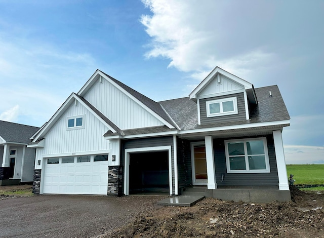 2333 Jandell Ave NE, Saint Michael, MN 55376 - view of front of house featuring a porch, driveway, a garage, and board and batten siding