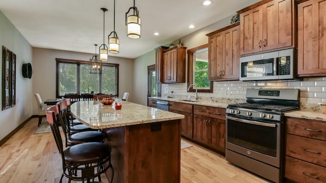 30488 292nd St, Lake Holcombe Twp, WI 54745 - kitchen featuring stainless steel appliances, light wood-type flooring, a kitchen island, decorative backsplash, and recessed lighting