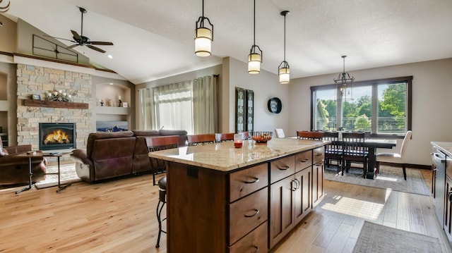 30488 292nd St, Lake Holcombe Twp, WI 54745 - kitchen with healthy amount of natural light, a kitchen bar, light wood-style floors, ceiling fan, and vaulted ceiling
