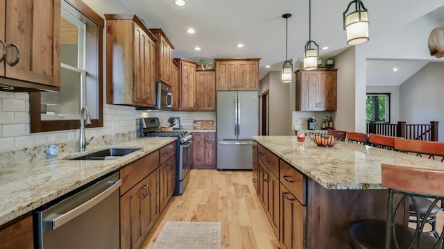30488 292nd St, Lake Holcombe Twp, WI 54745 - kitchen featuring stainless steel appliances, a breakfast bar area, light wood-style floors, a kitchen island, and decorative backsplash