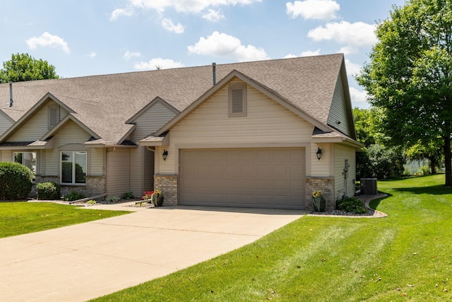 5209 Goodview Ln NW, Rochester, MN 55901 - view of front of house with an attached garage, concrete driveway, roof with shingles, a front lawn, and brick siding
