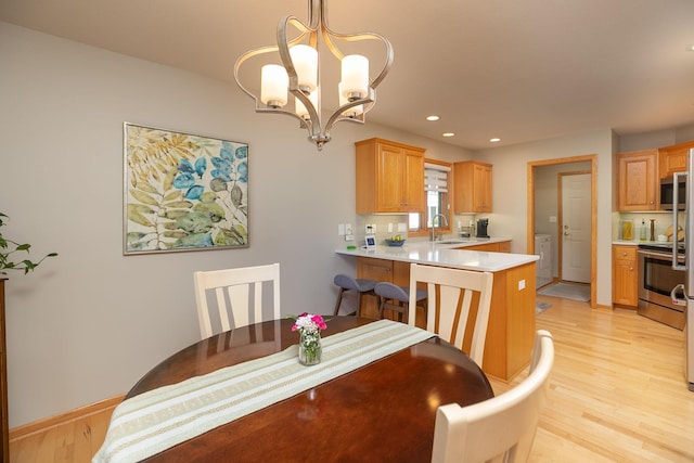5209 Goodview Ln NW, Rochester, MN 55901 - dining space with light wood-style floors, a chandelier, and recessed lighting