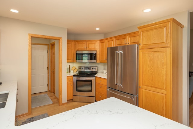 5209 Goodview Ln NW, Rochester, MN 55901 - kitchen with appliances with stainless steel finishes, light wood-style flooring, light countertops, decorative backsplash, and recessed lighting