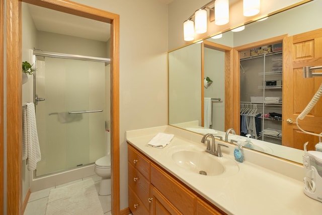 5209 Goodview Ln NW, Rochester, MN 55901 - bathroom featuring a stall shower, vanity, tile patterned flooring, and a walk in closet