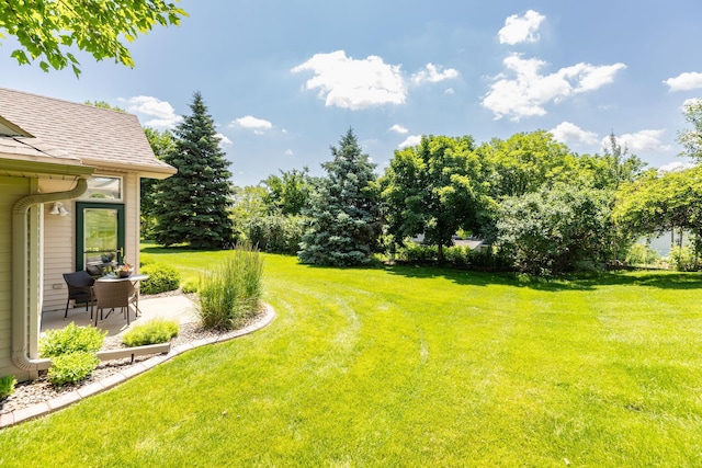 5209 Goodview Ln NW, Rochester, MN 55901 - view of grassy yard with a patio