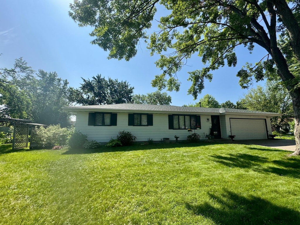 3602 Ridge Ave, Anoka, MN 55303 - ranch-style home with an attached garage, a front lawn, and asphalt driveway