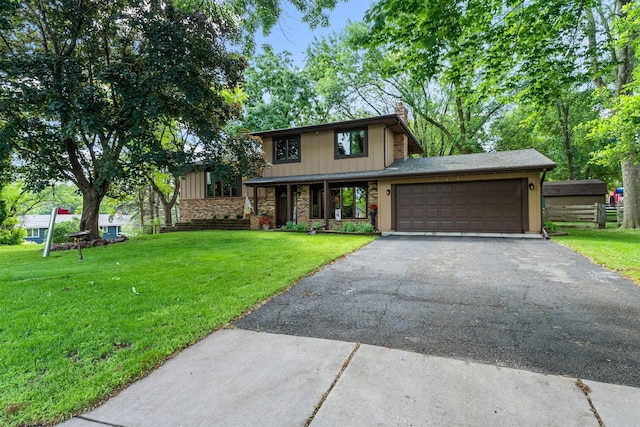9009 44th Cir N, New Hope, MN 55428 - view of front of property with a front lawn, a garage, asphalt driveway, a chimney, and board and batten siding