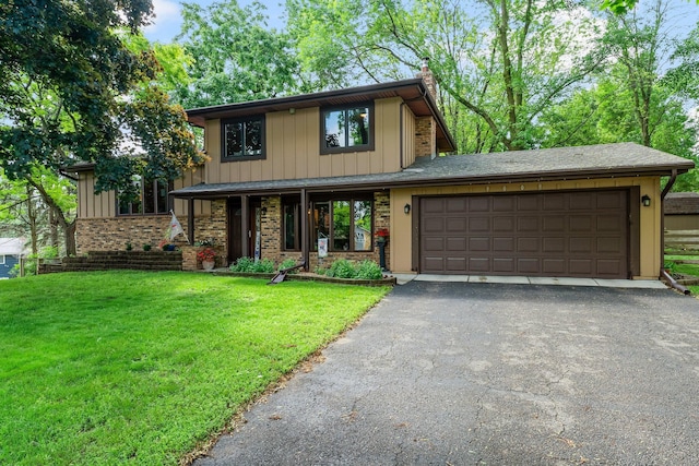 9009 44th Cir N, New Hope, MN 55428 - view of front of home with asphalt driveway, an attached garage, a front lawn, a chimney, and board and batten siding