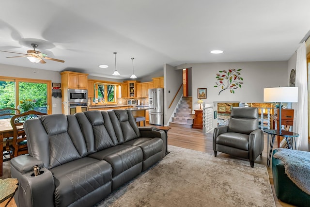 9009 44th Cir N, New Hope, MN 55428 - living area featuring a ceiling fan, light wood-style flooring, recessed lighting, stairway, and vaulted ceiling