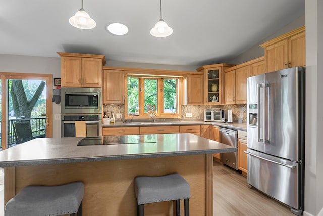 9009 44th Cir N, New Hope, MN 55428 - kitchen with stainless steel appliances, healthy amount of natural light, a breakfast bar area, and tasteful backsplash