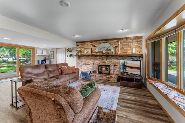 9009 44th Cir N, New Hope, MN 55428 - living room featuring wood finished floors and a brick fireplace