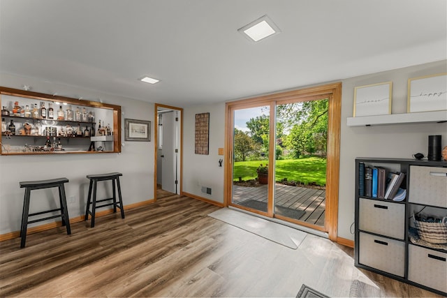 9009 44th Cir N, New Hope, MN 55428 - doorway to outside featuring wood finished floors and a dry bar