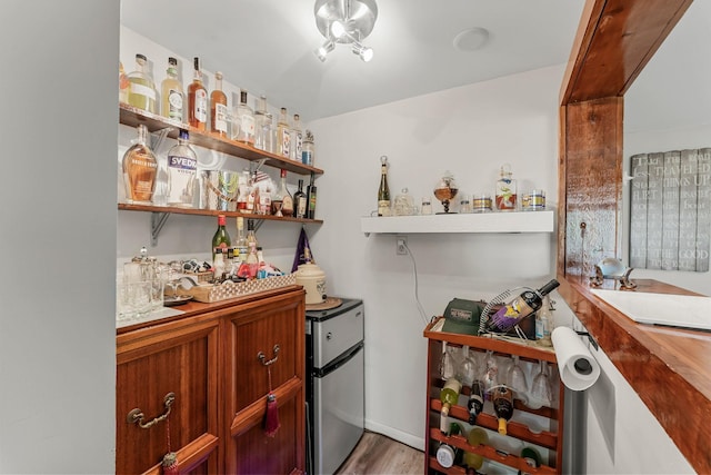 9009 44th Cir N, New Hope, MN 55428 - indoor dry bar with freestanding refrigerator and wood finished floors