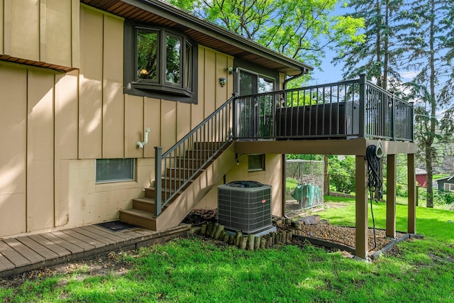 9009 44th Cir N, New Hope, MN 55428 - rear view of property with stairway, board and batten siding, a wooden deck, and a yard