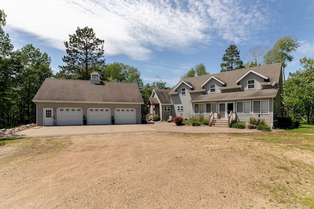 5393 Bachelor Rd NW, Hackensack, MN 56452 - view of front of home featuring dirt driveway, an outdoor structure, covered porch, a detached garage, and roof with shingles