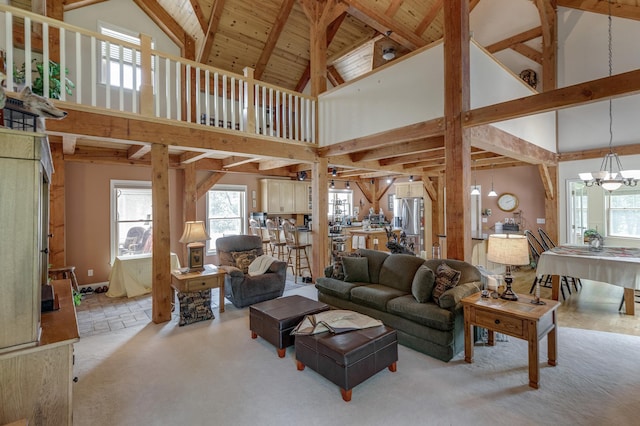 5393 Bachelor Rd NW, Hackensack, MN 56452 - living room featuring high vaulted ceiling, healthy amount of natural light, a chandelier, beamed ceiling, and carpet