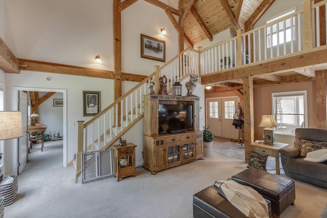 5393 Bachelor Rd NW, Hackensack, MN 56452 - carpeted living room with high vaulted ceiling, stairway, and a wooden ceiling with exposed beams