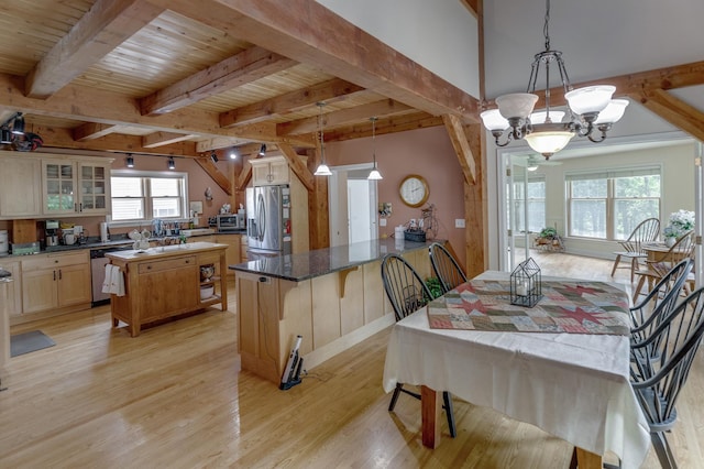 5393 Bachelor Rd NW, Hackensack, MN 56452 - kitchen featuring stainless steel appliances, light wood-type flooring, a chandelier, a peninsula, and glass insert cabinets