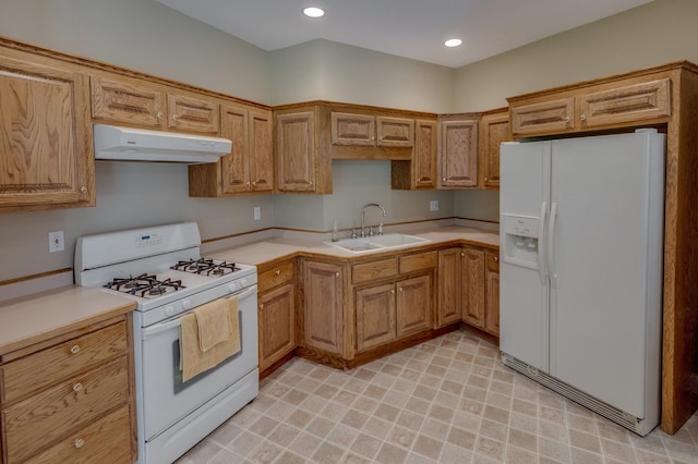 5393 Bachelor Rd NW, Hackensack, MN 56452 - kitchen with white appliances, under cabinet range hood, light countertops, brown cabinetry, and recessed lighting